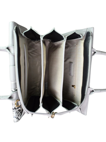 Close-up of a silver handbag with intricate design on a white background
